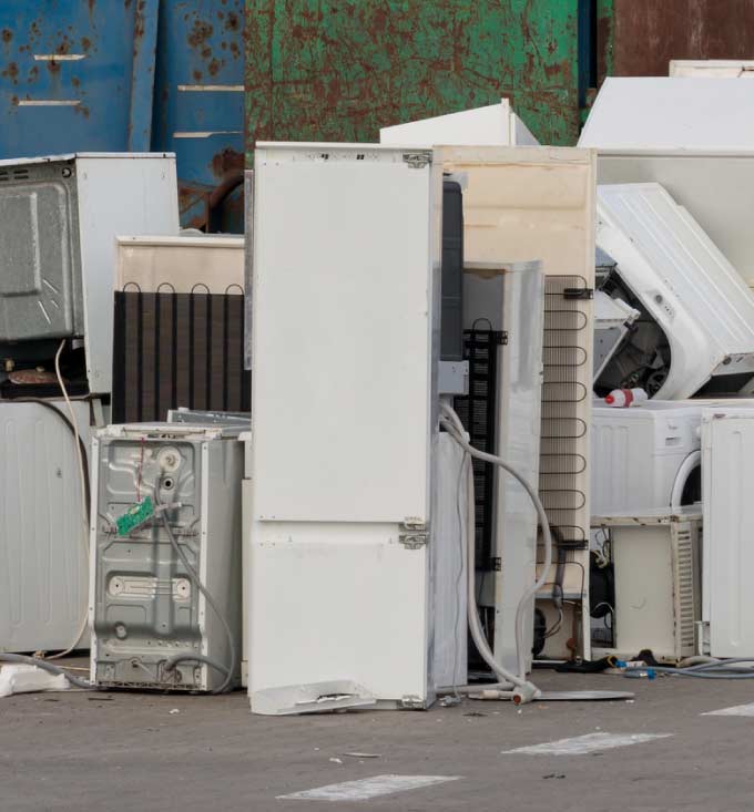 Cleaning up and hauling away a variety of old household appliances for eco-conscious disposal practices in tualre ca
